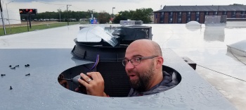 Technician inspecting HVAC components inside a home