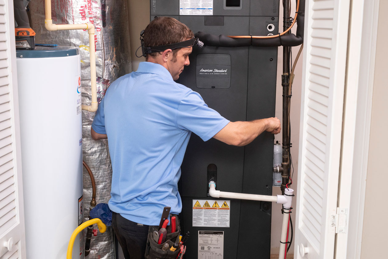 HVAC technician installing a gas furnace in a Northwest Chicago home