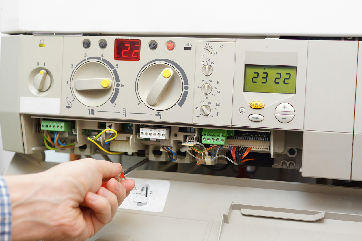 HVAC technician performing a tune-up on a home furnace