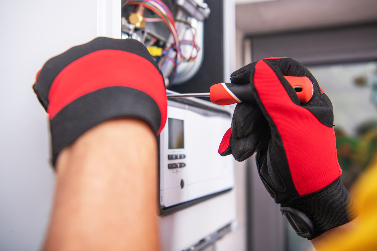 HVAC technician repairing a home furnace