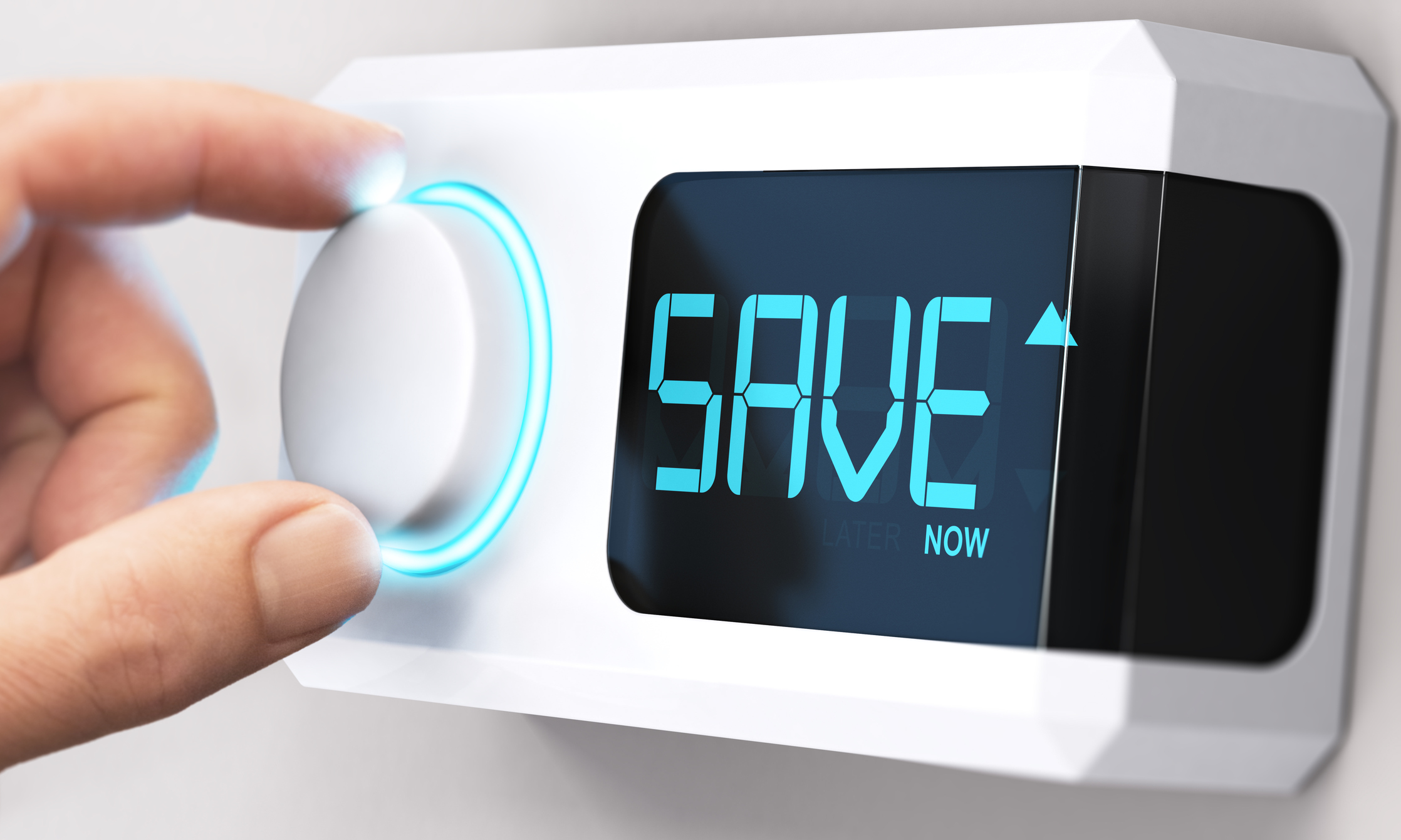 Hand on the knob of a thermostat that says “Save now!