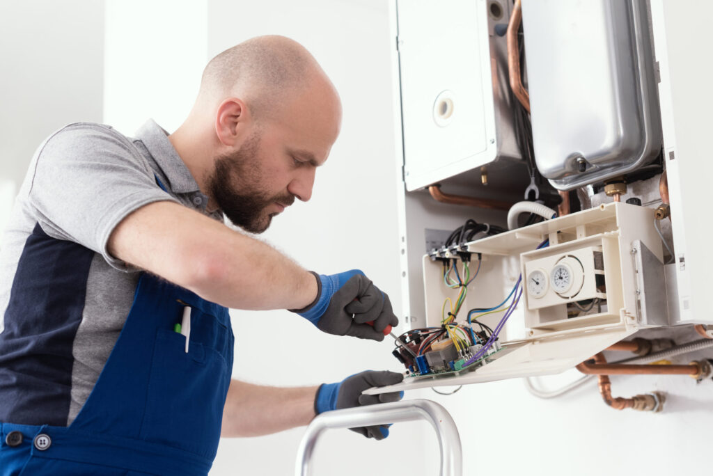 Professional qualified engineer servicing a natural gas boiler at home